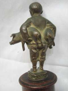 neat vintage bronze statue of a boy with pigs. No apparent makers 