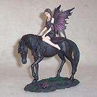 Fairy Sitting Against Black Unicorn Figurine  